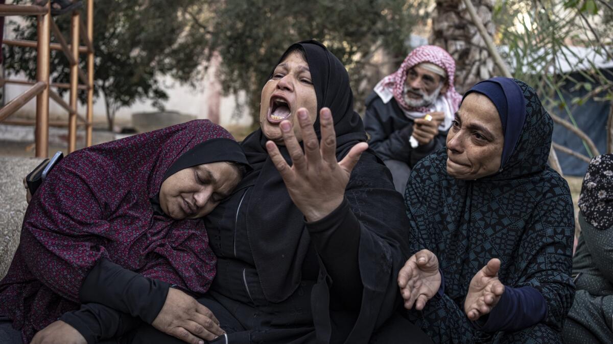 Palestinians mourn their relatives killed in the Israeli bombardment of the Gaza Strip, in the hospital in Khan Younis. - AP