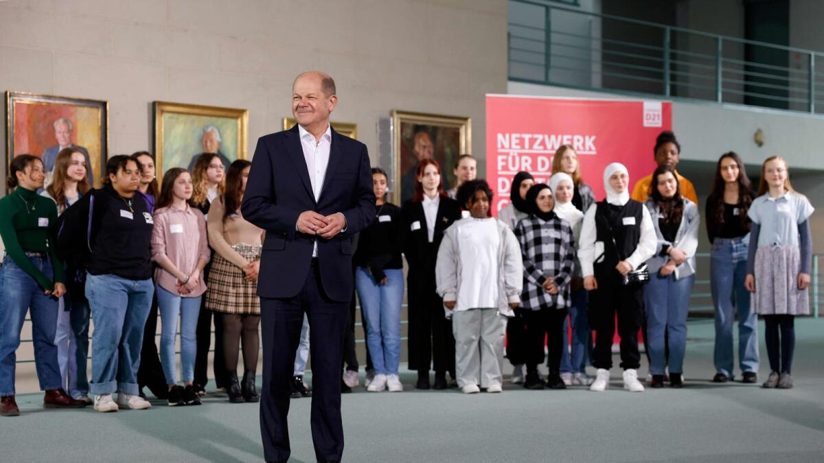 German Chancellor Olaf Scholz poses with students as he hosts the annual Girls' Day event. —AFP