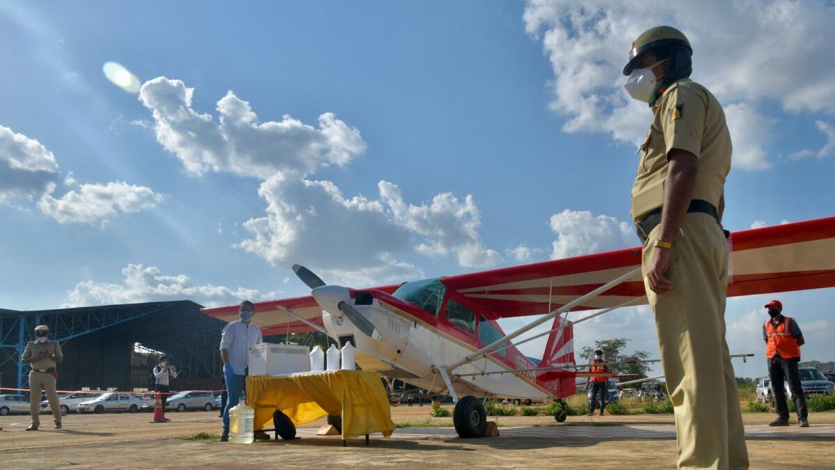 A security personnel stands next to a light aircraft at Jakkur aerodrome in Bangalore. Photo: AFP