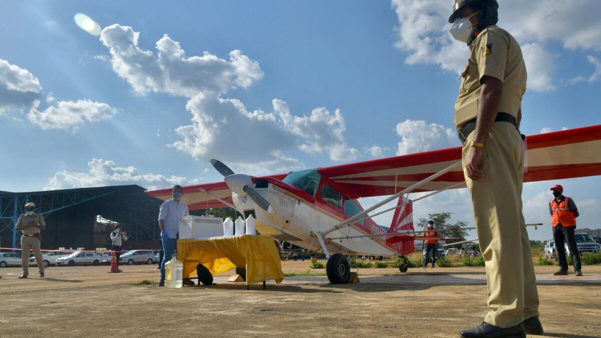 A security personnel stands next to a light aircraft at Jakkur aerodrome in Bangalore. Photo: AFP