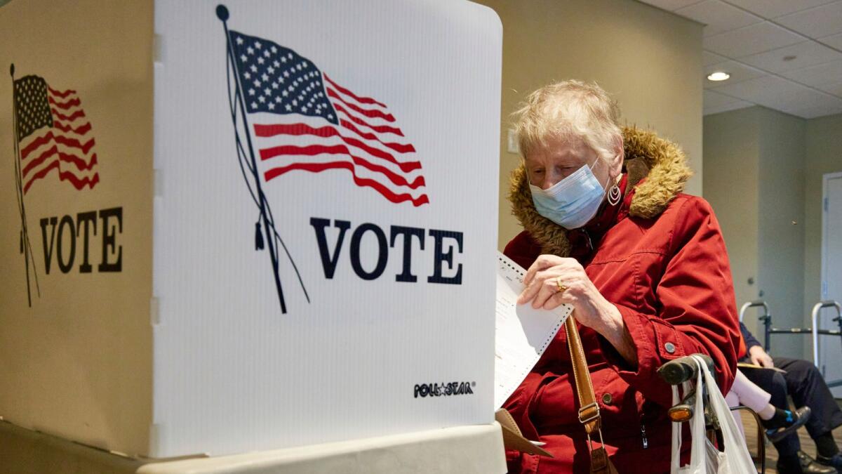 A resident fills out her ballot during early voting. Photo: AP