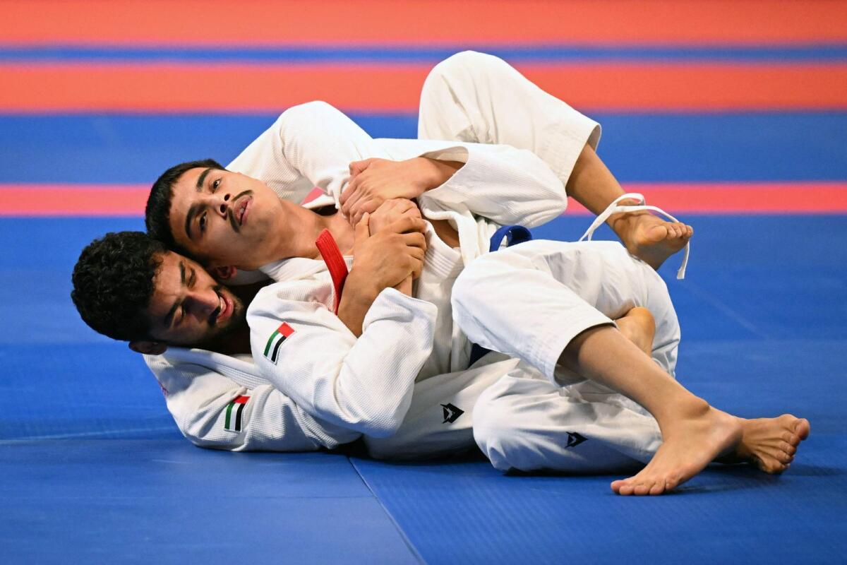United Arab Emirates' Khalid Alblooshi (front) competes against compatriot Khaled Alshehi (back) at the Jiu-Jitsu men's 62kg final event during the Hangzhou 2022 Asian Games. Photo: AFP