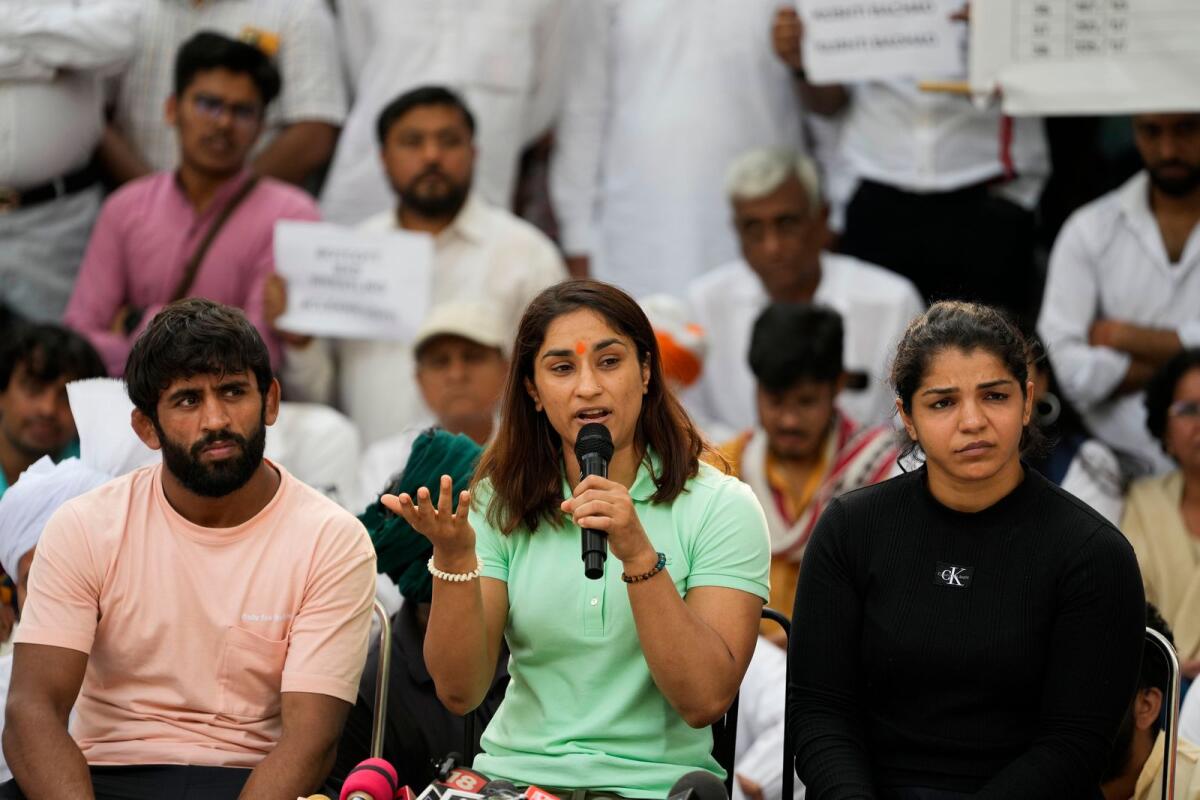 Wrestlers Bajrang Punia, Vinesh Phogat and Sakshi Malik addresses a press conference during their ongoing protest at Jantar Mantar in New Delhi on Friday. — PTI