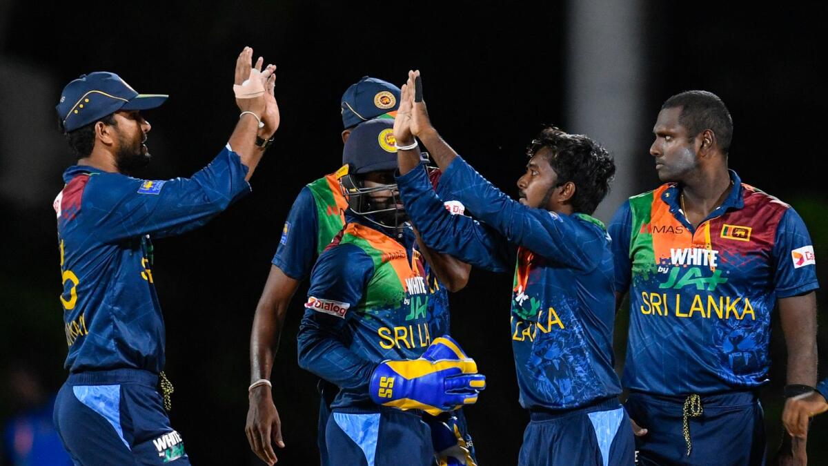 Senior players Dinesh Chandimal (left), Akila Dananjaya (centre) and Angelo Mathews (right) are unhappy with the Sri Lankan cricket board. (AFP)