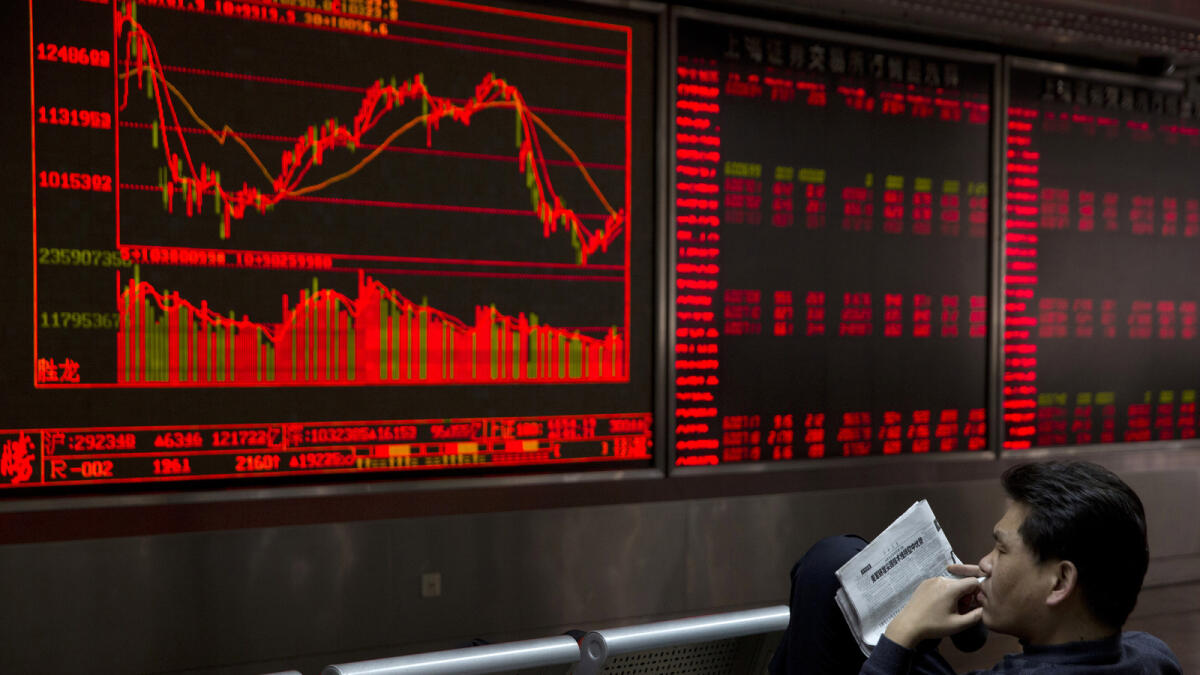 Chinese investors monitor stock prices at a brokerage in Beijing, China, Monday, Feb. 22, 2016.  Global stock markets rose Monday as investors looked to this weeks meeting of finance ministers from major economies for reassurance about threats to world g
