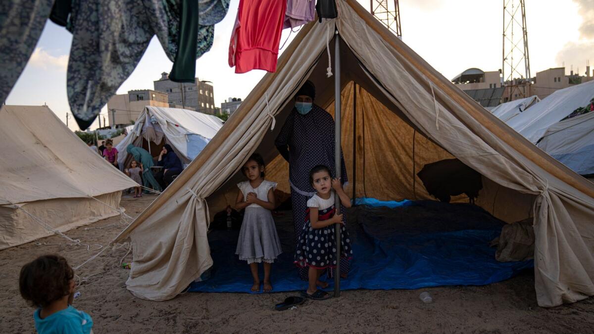 Palestinian children displaced by the Israeli bombardment of the Gaza Strip stay in a UNDP-provided tent camp in Khan Younis. — AP
