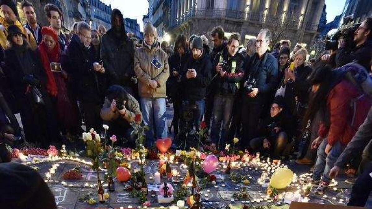 People put candles on painted hearts with the Belgian colors to mourn for the victims.