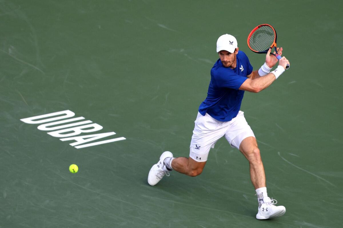 Britain's Andy Murray hits a backhand return during his round of 32 match against Canada's Denis Shapovalov in Dubai on Monday. — Reuters