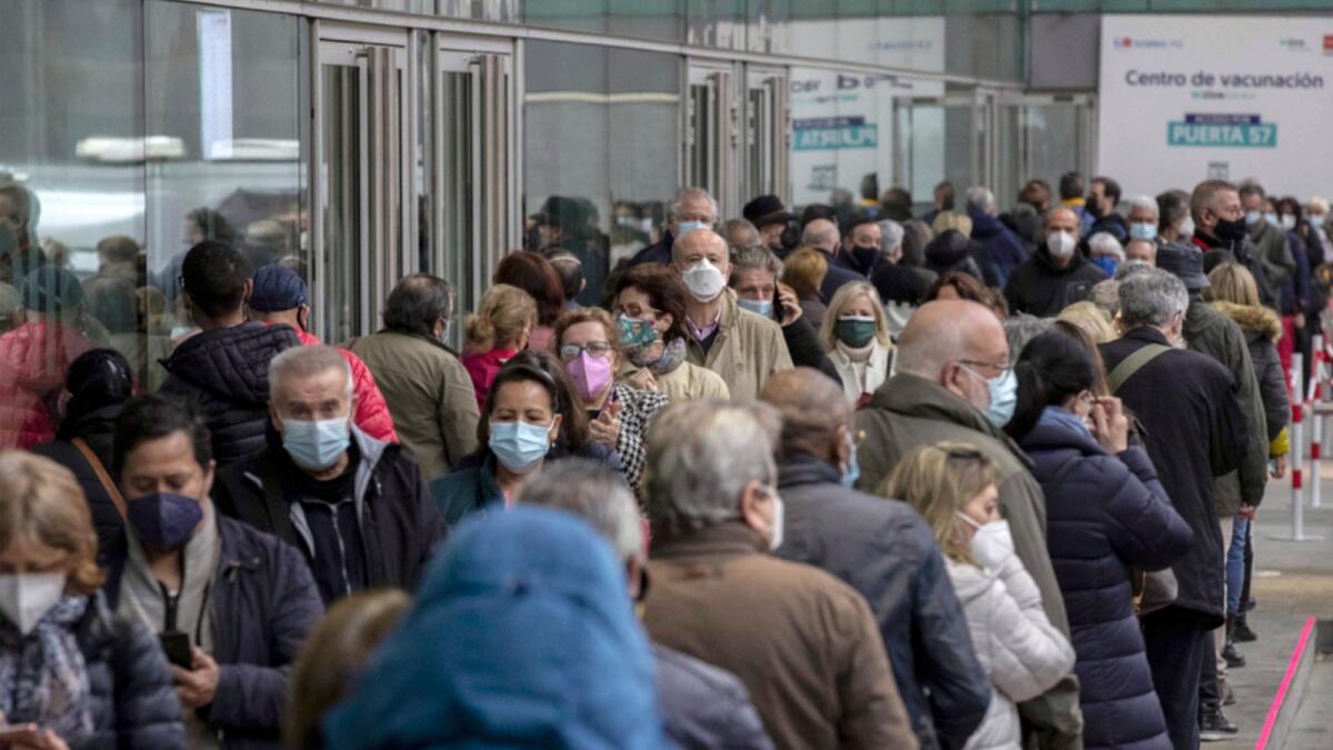 People queue up to be vaccinated against Covid-19 during a  campaign in Madrid. — AP