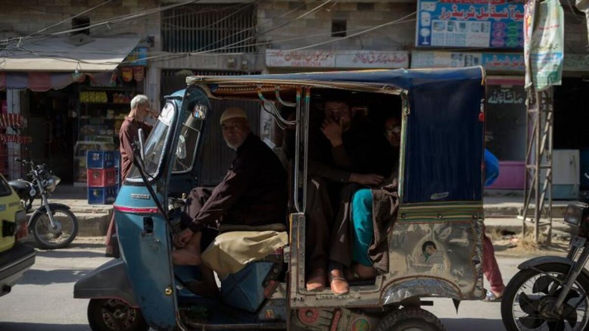 A family travel on a rickshaw along a street in Rawalpindi, Pakistan. Photo for illustrative purposes only.