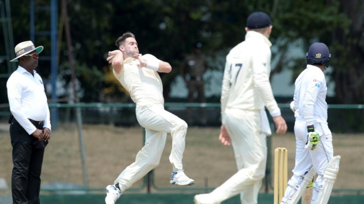 England all-rounder Chris Woakes bowling during the curtailed tour of Sri Lanka. - AFP file