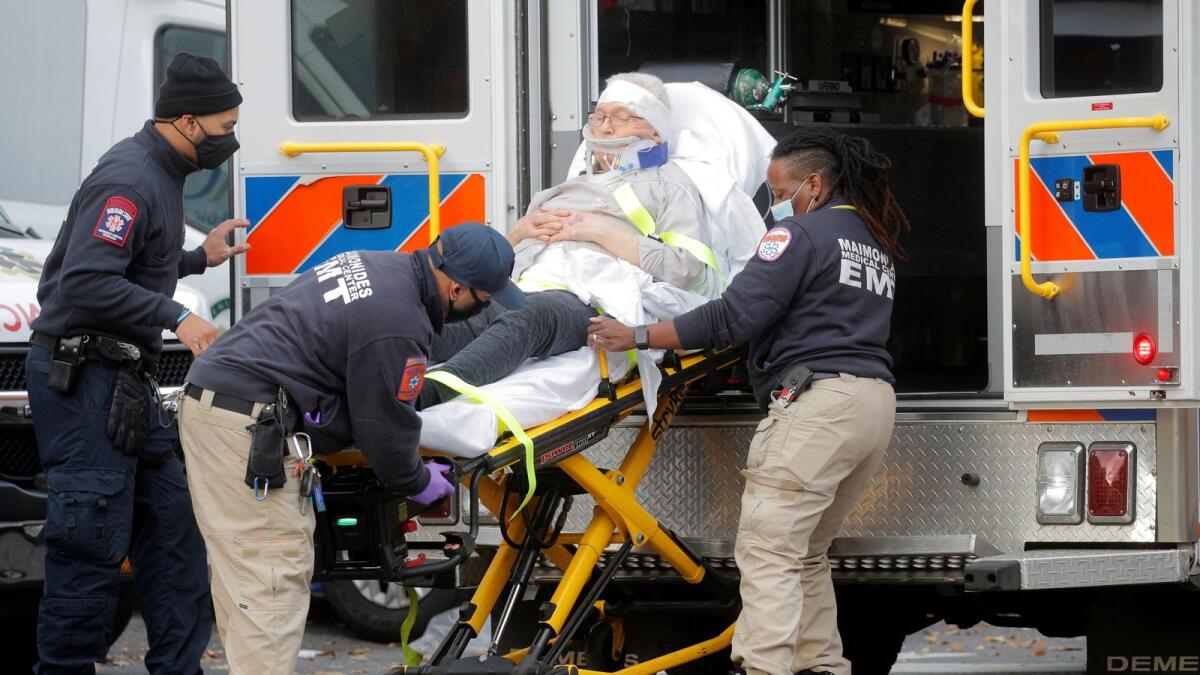 A patient arrives outside Maimonides Medical Center in Brooklyn, New York.