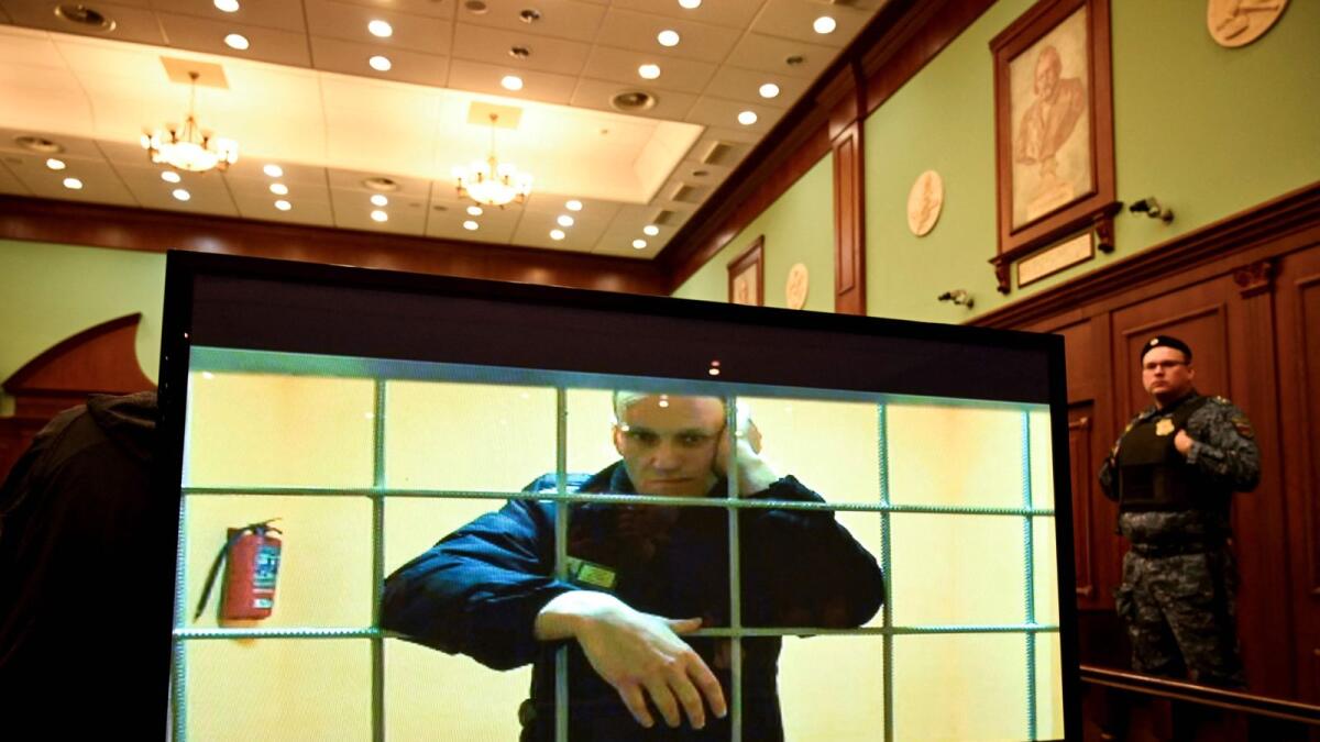 Opposition leader Alexei Navalny appears on a screen set up at a courtroom of the Moscow City Court via a video link from his prison colony during a hearing of an appeal against his nine-year prison sentence he was handed in March after being found guilty of embezzlement and contempt of court in Moscow. — AFP  file