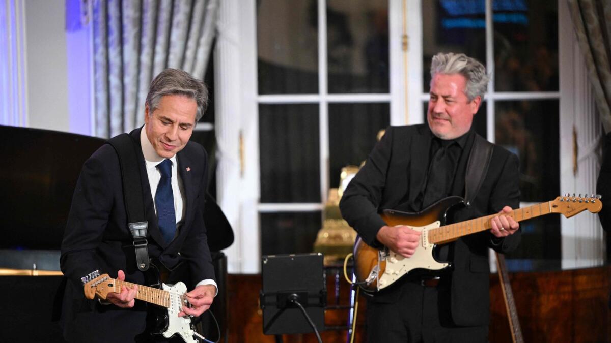 US Secretary of State Antony Blinken performs during a celebration marking the launch of the Music Diplomacy Initiative in the Benjamin Franklin Room of the State Department in Washington, DC, on September 27, 2023. — AFP