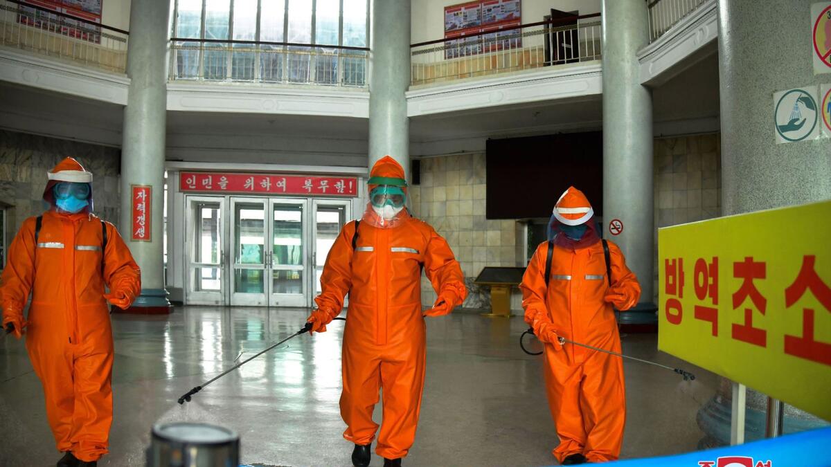 This picture taken on May 17, 2022 and released from North Korea's official Korean Central News Agency (KCNA) on May 18 shows railway station staff disinfecting Pyongyang station premises. Photo: AFP