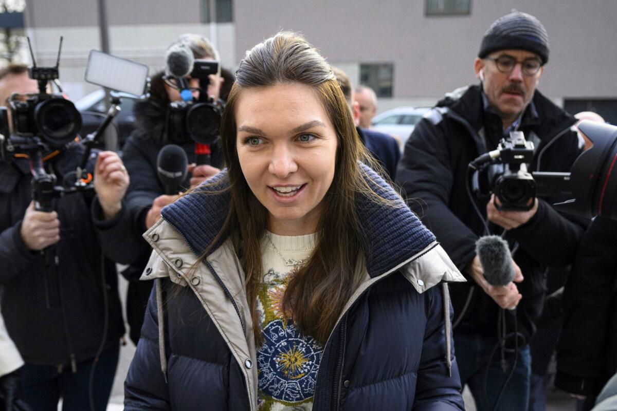 Former WTA number 1 tennis player Simona Halep of Romania is surrounded by the media for a hearing in the arbitration procedures against International Tennis Integrity Agency (ITIA) at the international Court of Arbitration for Sport, CAS, in Lausanne, Switzerland. - AP