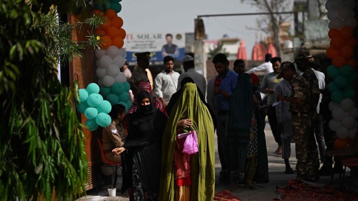 Voters arrive to cast their ballots at a polling station during the first phase of India's general election in Kairana, Uttar Pradesh. — AFP