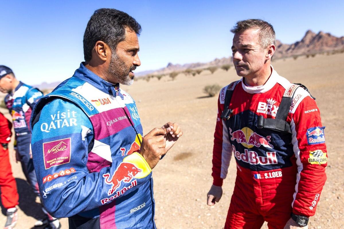 Sebastien Loeb of Bahrain Raid Xtreme in discussion with Nasser Al Attiyah. - Supplied photo