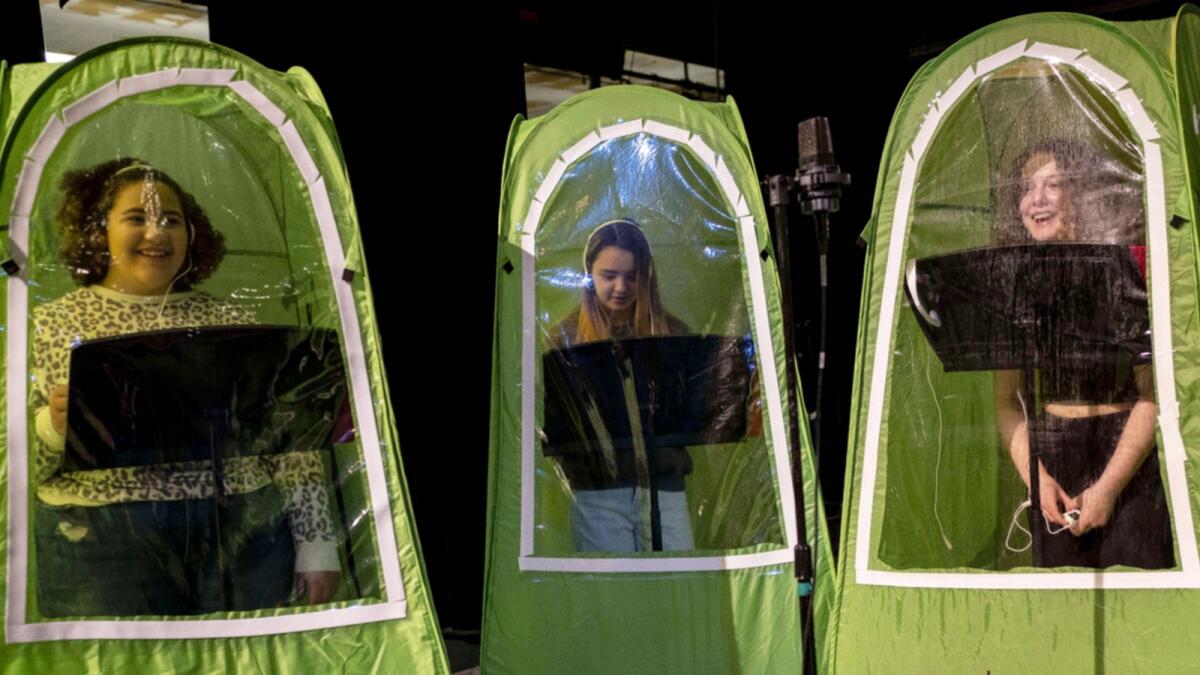 Students record vocals in pop-up tents during choir class at Wenatchee High School in  Washington. The school has been using pop-up tents as Covid-19 enclosures for its music programs as students return to classrooms. — AFP