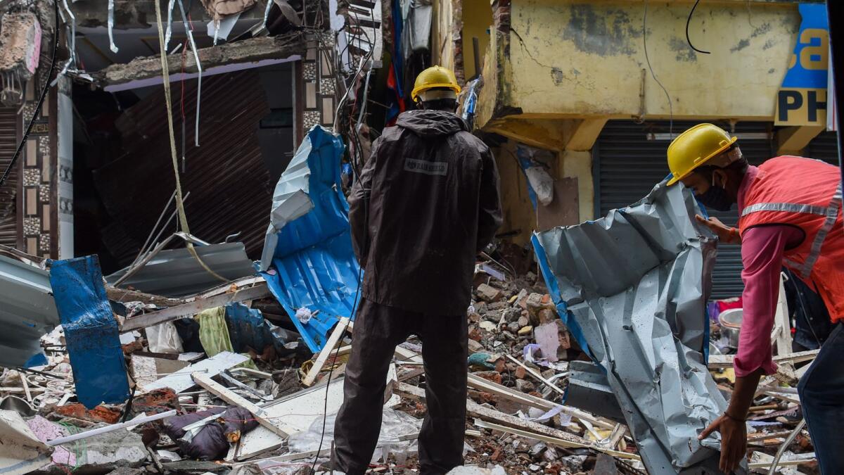 Civil authority workers remove debris from a collapsed building in Mumbai. Photo: AFP