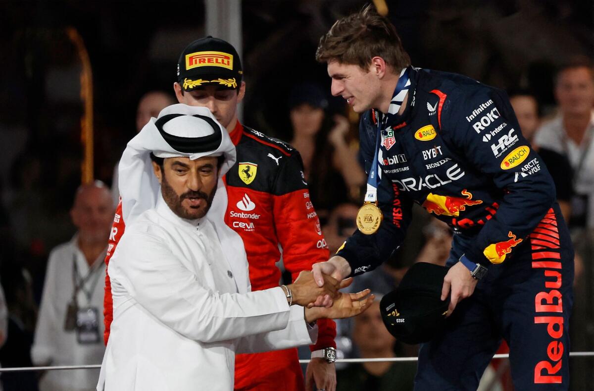 Red Bull's Max Verstappen shakes hands with FIA president Mohammed Ben Sulayem on the podium. — Reuters