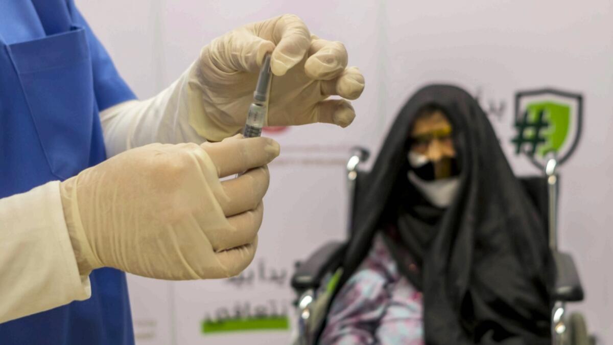 A senior Emirati woman receives Covid-19 vaccine in Jumeirah, Dubai. — Photo by Shihab