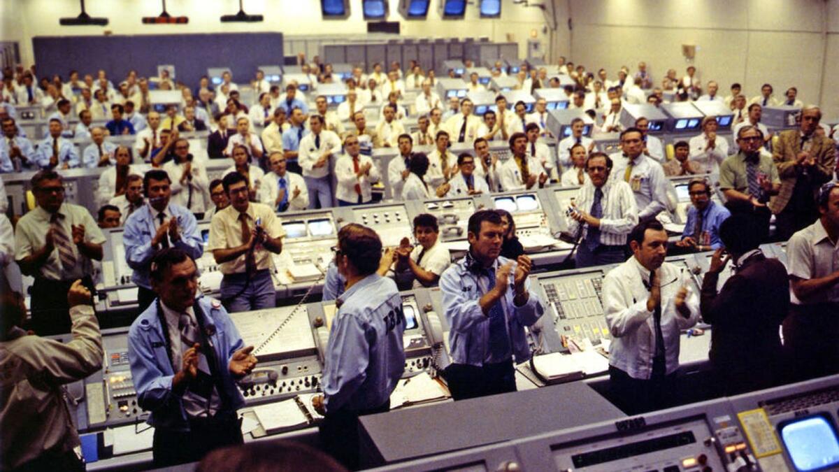 A photo provided by NASA shows firing room team members cheering the launch of Apollo 17 on Dec. 7, 1972 at Kennedy Space Center in Florida.  (NASA via The New York Times)