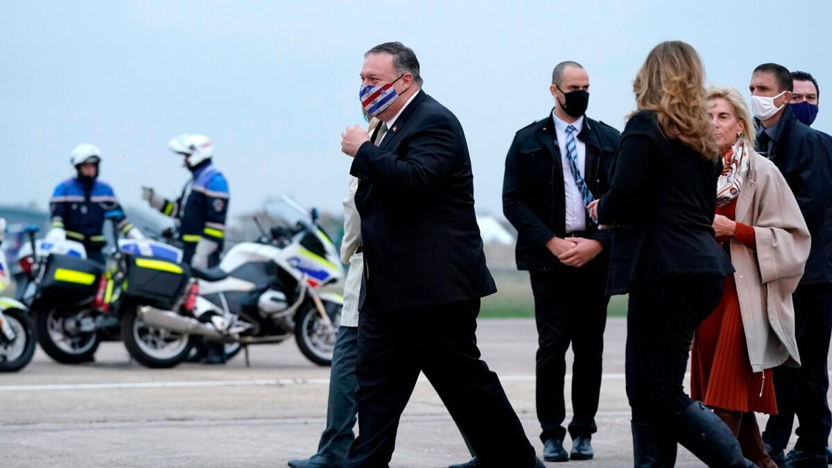 Secretary of State Mike Pompeo walks to a motorcade after stepping off a plane at Paris Le Bourget Airport on Saturday. — AFP