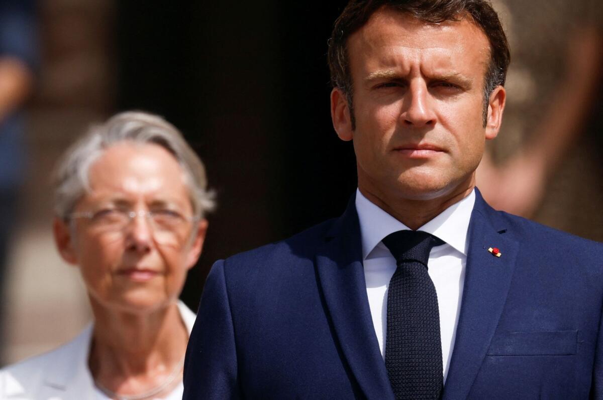 French President Emmanuel Macron (R) and French Prime Minister Elisabeth Borne (L) attend a ceremony. Photo: AFP