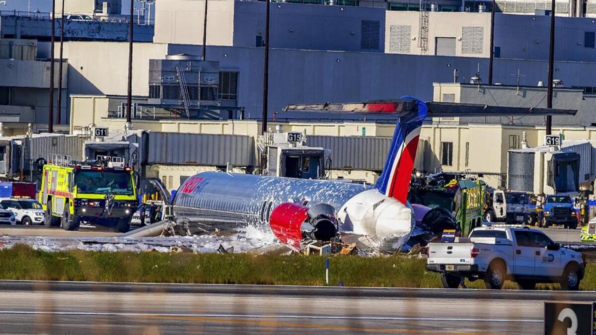 Firefighting units are seen next to a Red Air plane that caught fire after the front landing gear collapsed upon landing. Tuesday, June 21, 2022. Photo: AP