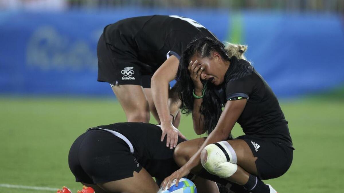 Portia Woodman, Kelly Brazier and Tyla Nathan-Wong of New Zealand react after their loss to Australia in the women's rugby gold medal match. Reuters