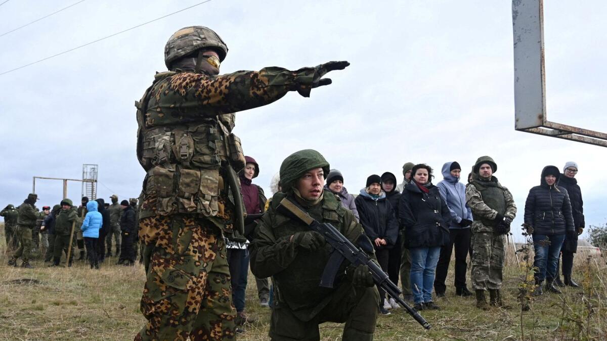 Participants listen to the instructor during a combat training session for civilians organised by local authorities at a range in Rostov Region. — Reuters