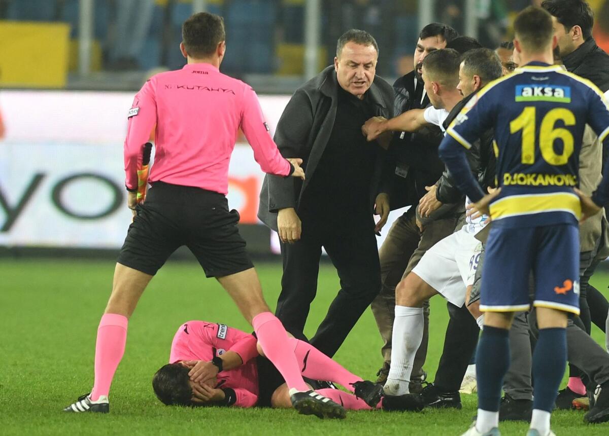 Referee Halil Umut Meler collapses after being punched in the face by Ankaragucu  president Faruk Koca. — Reuters