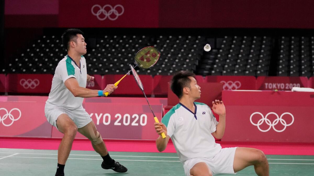 Taiwan's Wang Chi-Lin (left) and Lee Yang compete against China's Li Jun Hui and Liu Yu Chen during their men's doubles gold medal Badminton match at the 2020 Summer Olympics. — AP