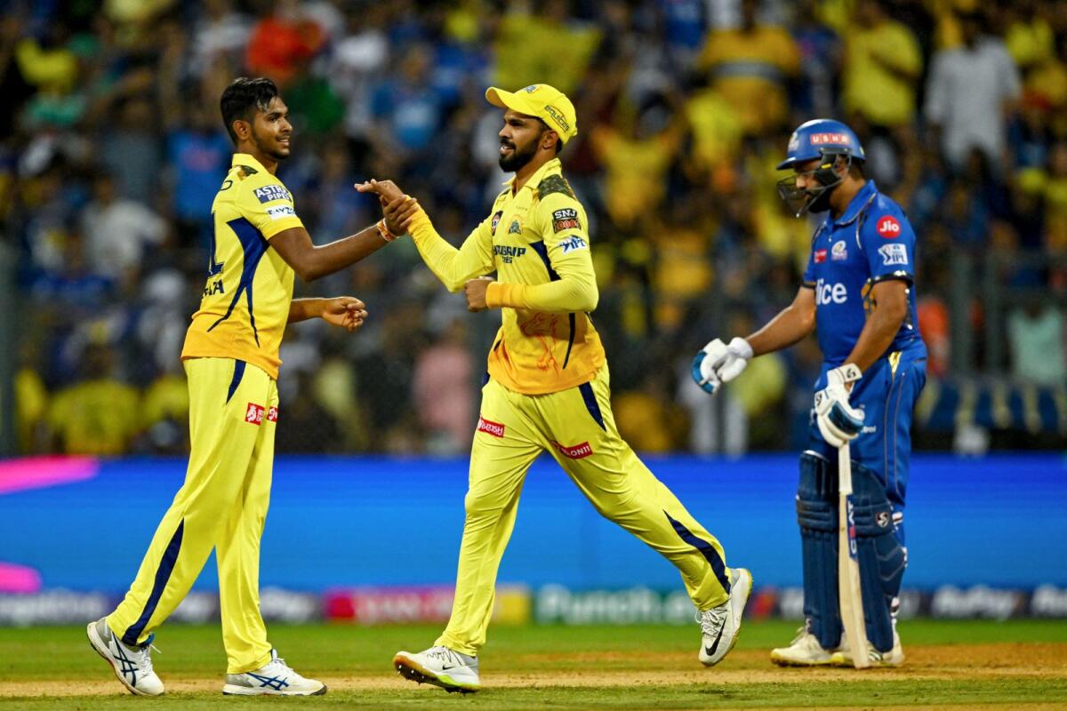 Chennai Super Kings Matheesha Pathirana (left) celebrates a wicket with captain Ruturaj Gaikwad (centre) as Rohit Sharma reacts. — AFP
