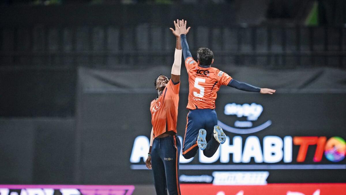 Dominic Drakes (left) of the Delhi Bulls celebrates with his teammate after grabbing four wickets against Team Abu Dhabi. — Abu Dhabi T10