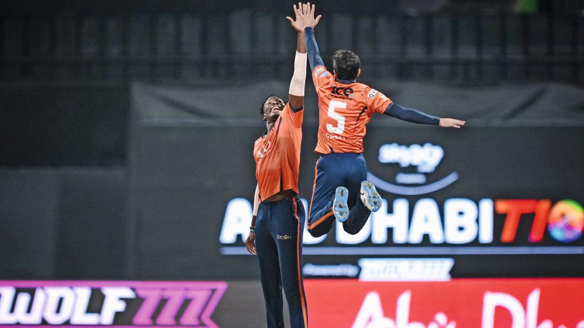 Dominic Drakes (left) of the Delhi Bulls celebrates with his teammate after grabbing four wickets against Team Abu Dhabi. — Abu Dhabi T10