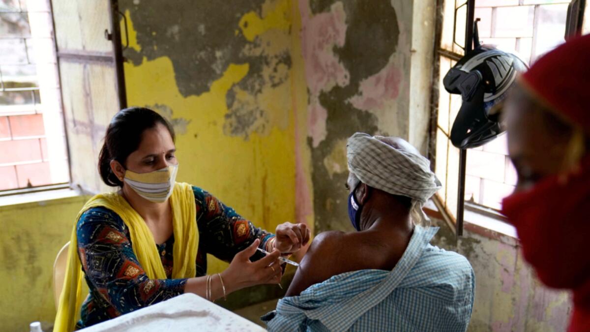 A health worker administers the vaccine for Covid-19 to a villager in village Nizampur, on the outskirts of New Delhi. — AP