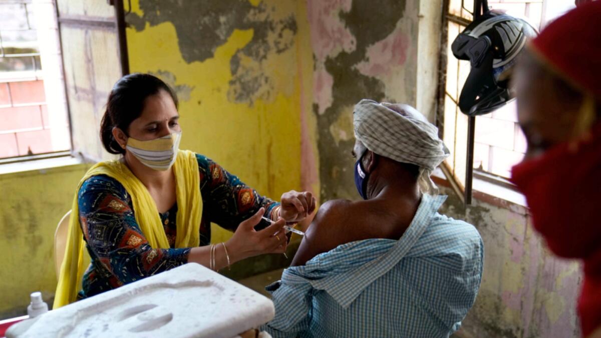 A health worker administers the vaccine for Covid-19 to a villager in village Nizampur, on the outskirts of New Delhi. — AP