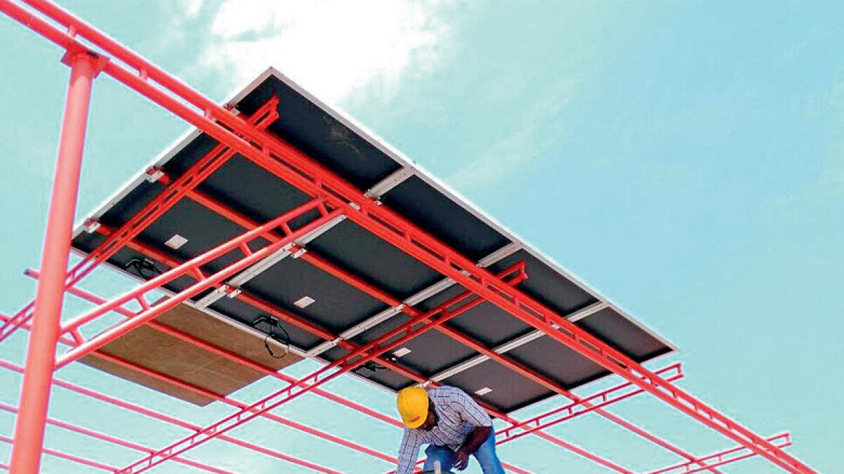 Workers installing solar panels at Woodlem Park School in Ajman. The school, which will open in April, will emerge as an active partner in country’s green initiatives, say promoters. 