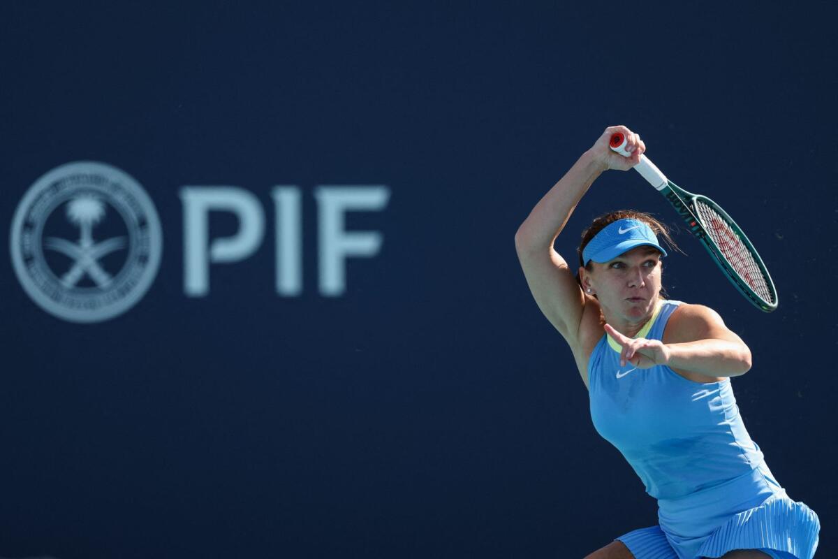 Simona Halep of Romania returns a shot to Paula Badosa of Spain. — AFP
