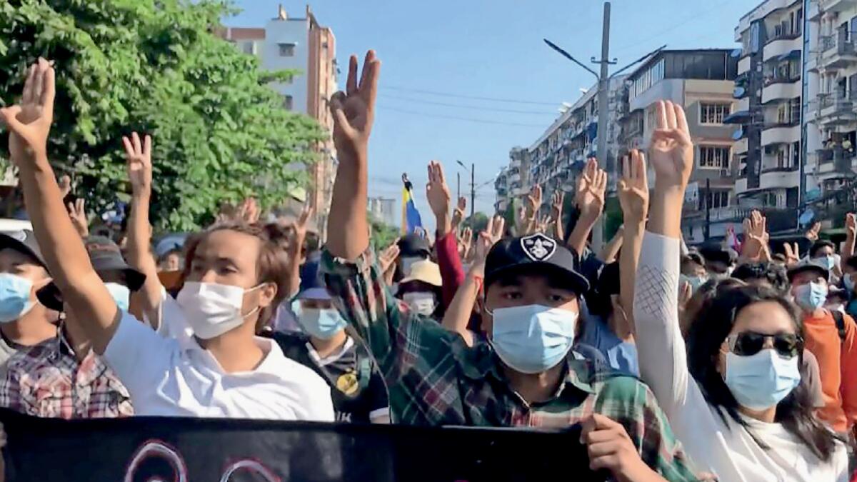 Protesters make the three-finger salute as they take part in demonstrations against the military coup in Yangon. – AFP