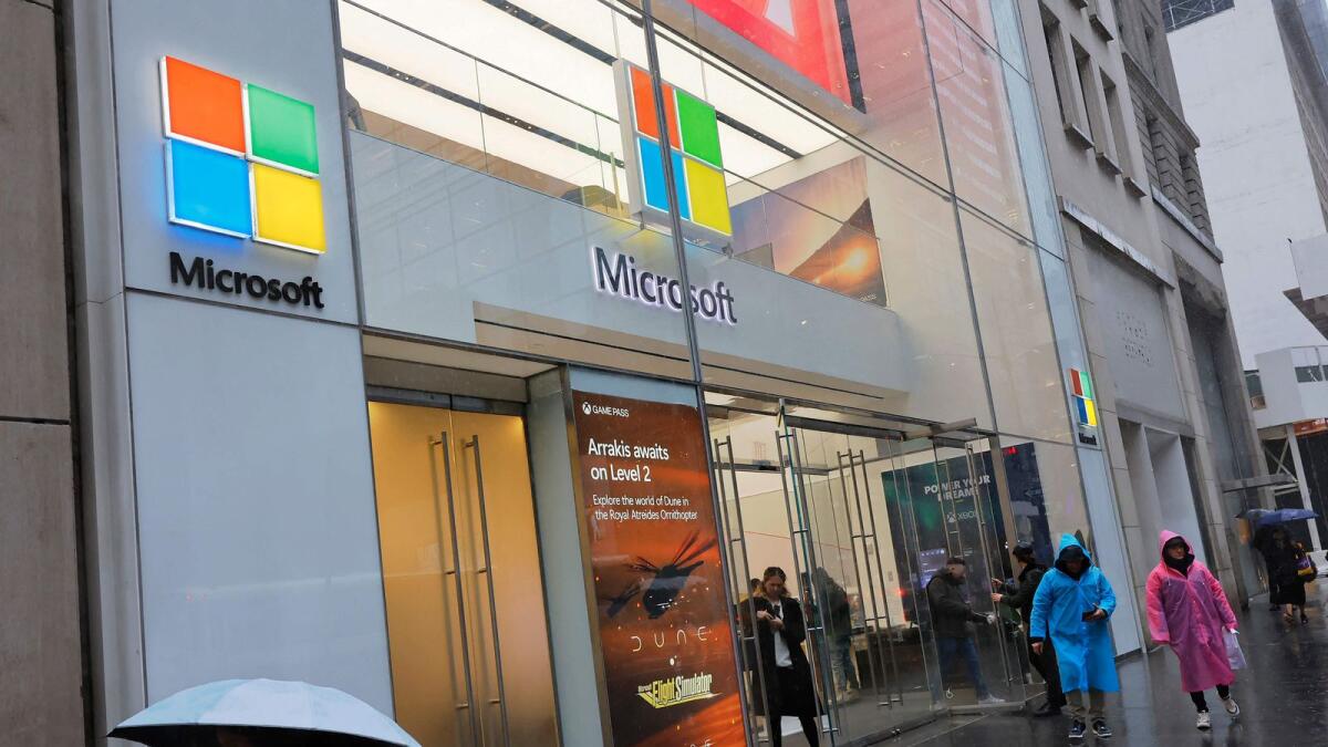 People walk past a Microsoft Experience Center in New York City. — AFP