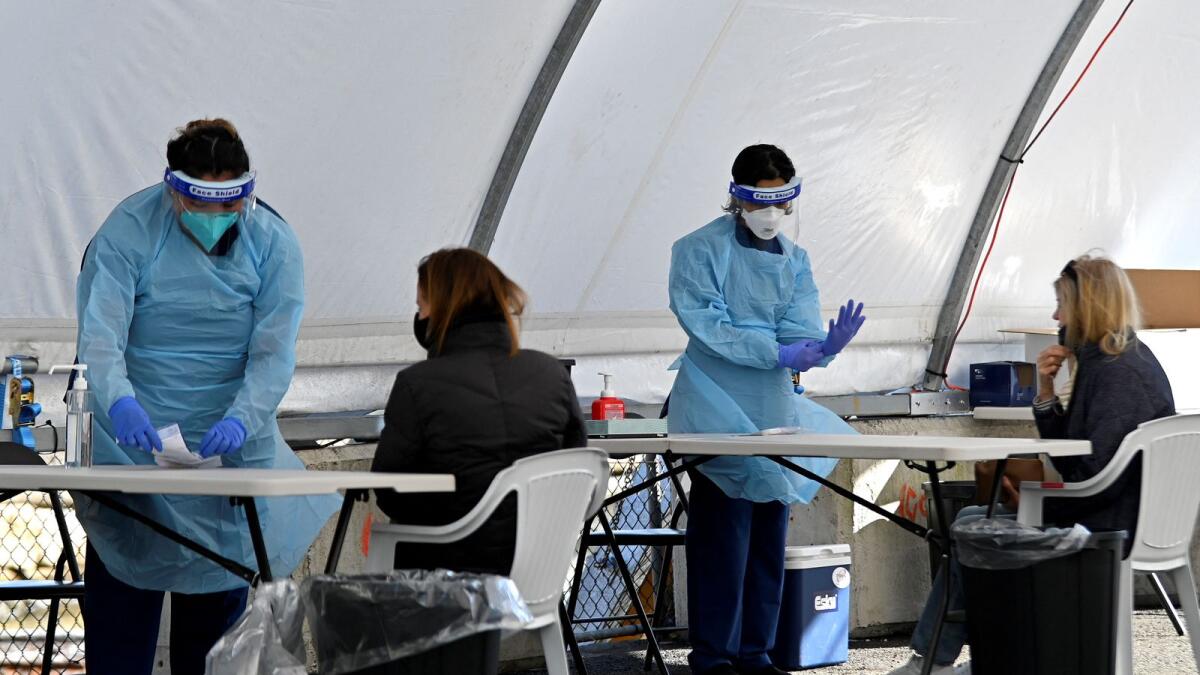 Health workers take swab samples from residents at a clinic in Sydney. Photo: AFP