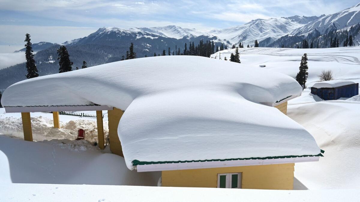 Snow covered huts are pictured at a ski resort in Kangdori, Gulmarg in Srinagar on February 2, 2023. — AFP