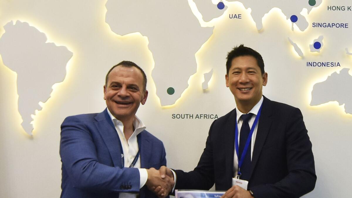Ahmad Abu Eideh, chief executive officer of UAB, and Jean-Pierre Ting, managing director of Toppan FutureCard, shaking hands after signing the agreement. — Supplied photo 