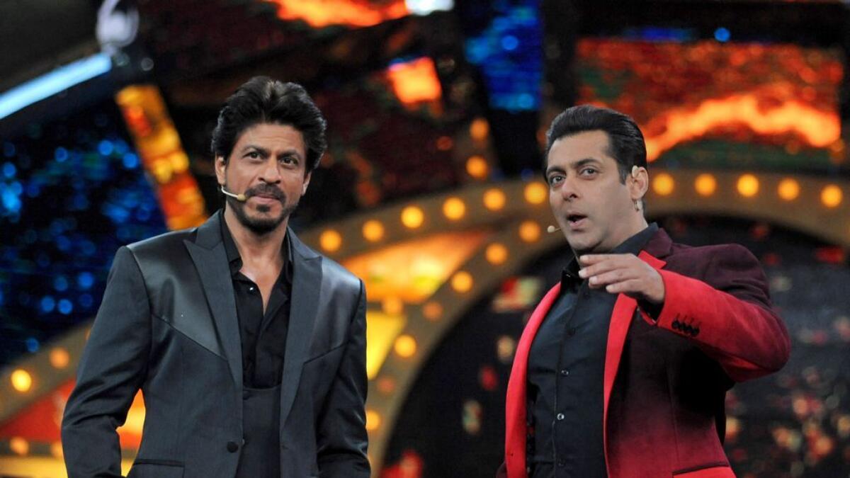 Indian Bollywood actors Shah Rukh Khan (L) and Salman Khan pose during the promotion of 'Raees', on the set of Colors television reality show 'Bigg Boss 10' in Lonavla on January 20, 2017.