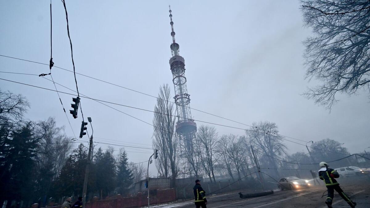 A fireman runs after Russian airstrike hit Kyiv's main television tower in Kyiv on March 1, 2022. Photo: AFP
