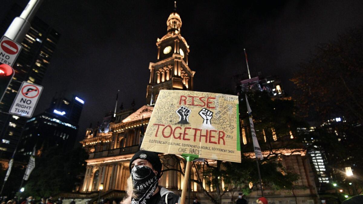 Protestors gather at the Town Hall for a Black Lives Matter protest rally to express solidarity with US protestors in Sydney on June 12, 2020 and demand an end to Aboriginal deaths in custody in Australia. Photo: AFP