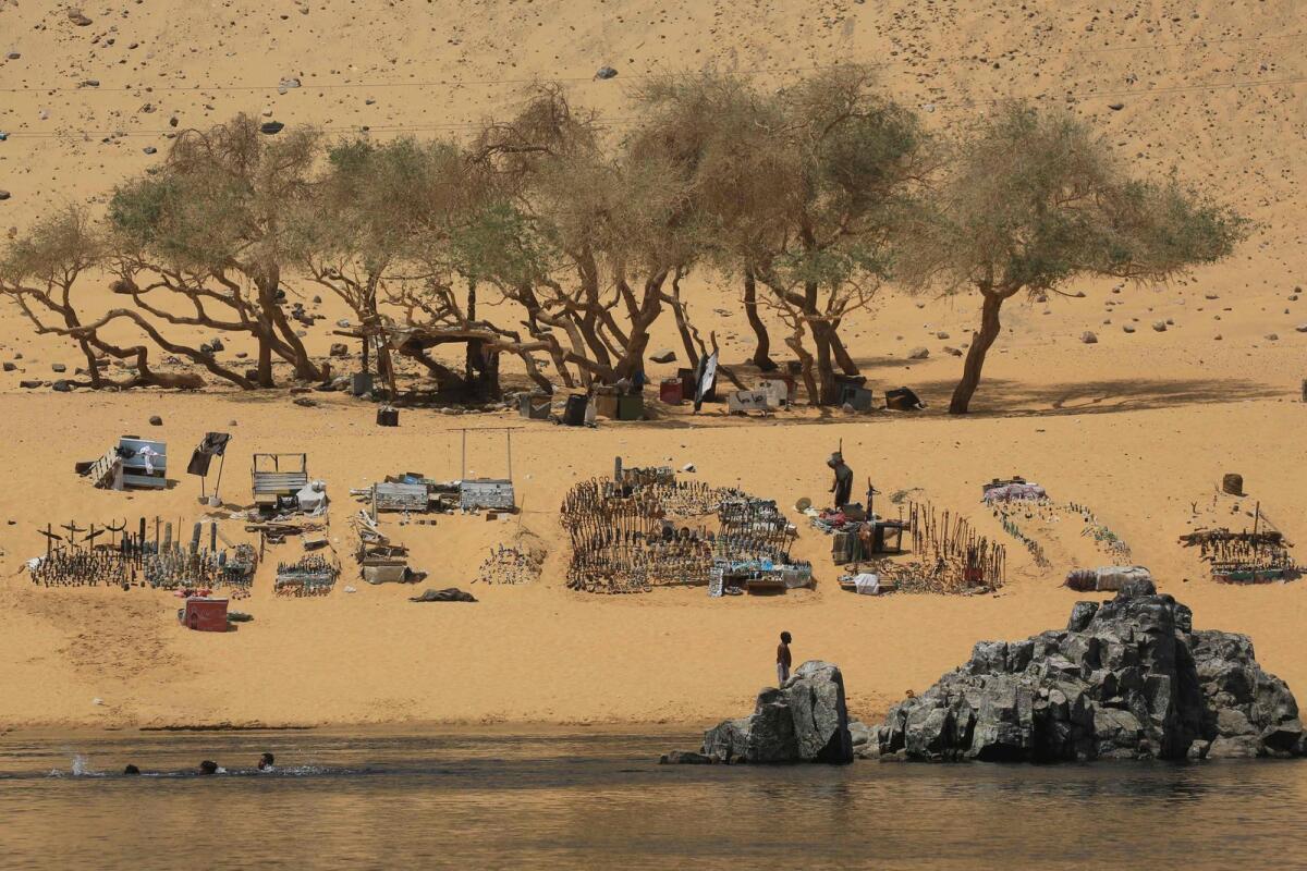 Sudanese who fled the war in their country gather on the banks of the Nile river in the Egyptian city of Aswan on September 8, 2023. — AFP